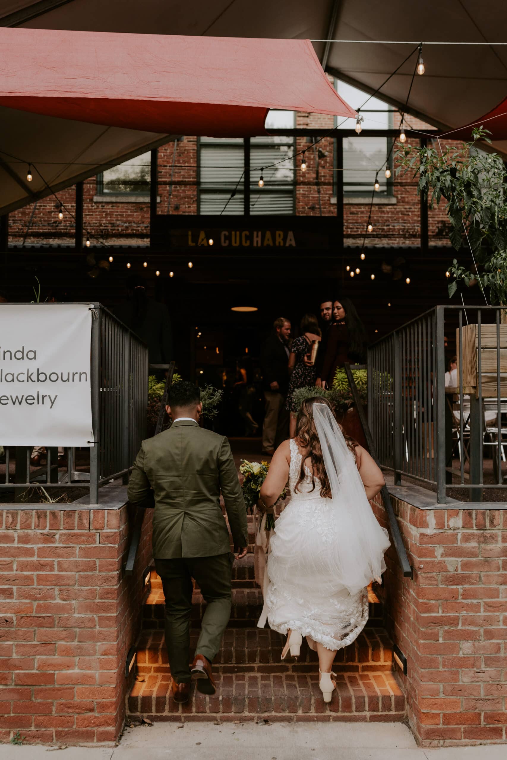 bride and groom walking into restaurant 