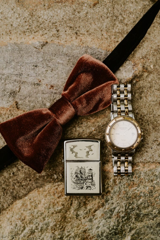 groom details- watch and cigar and bowtie