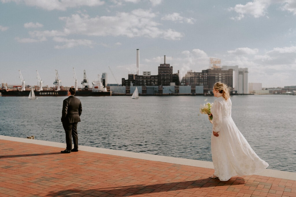 First look by baltimore harbor with bride and groom