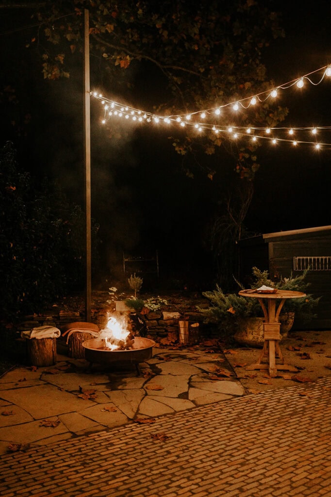 fire pit and string lights at night at Terrain wedding venue