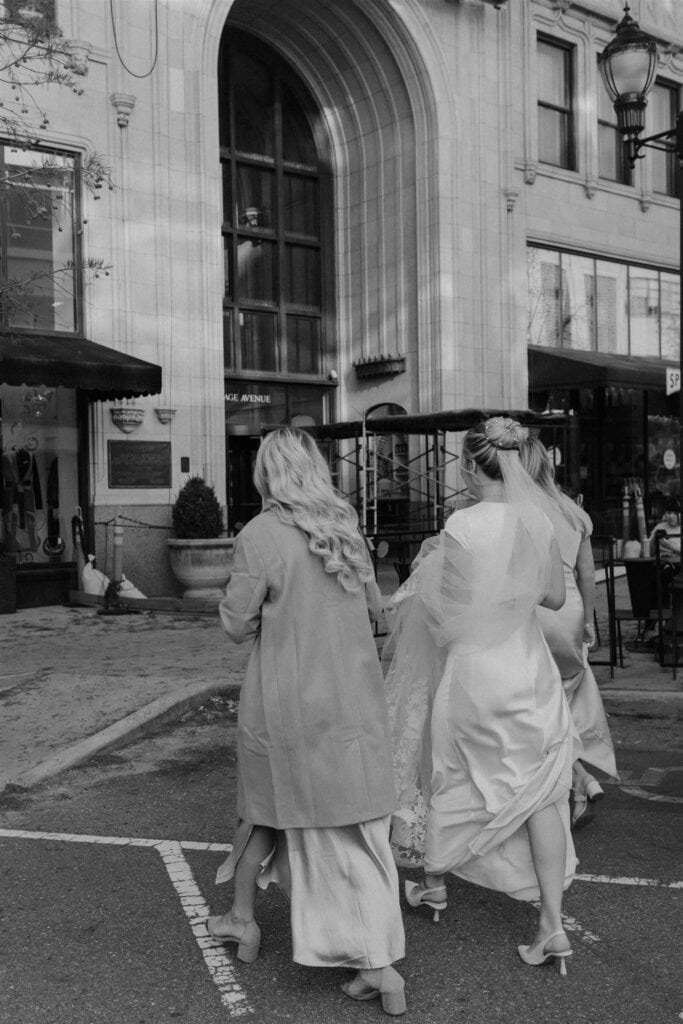 Bride and two bridesmaids crossing the street in downtown Asheville