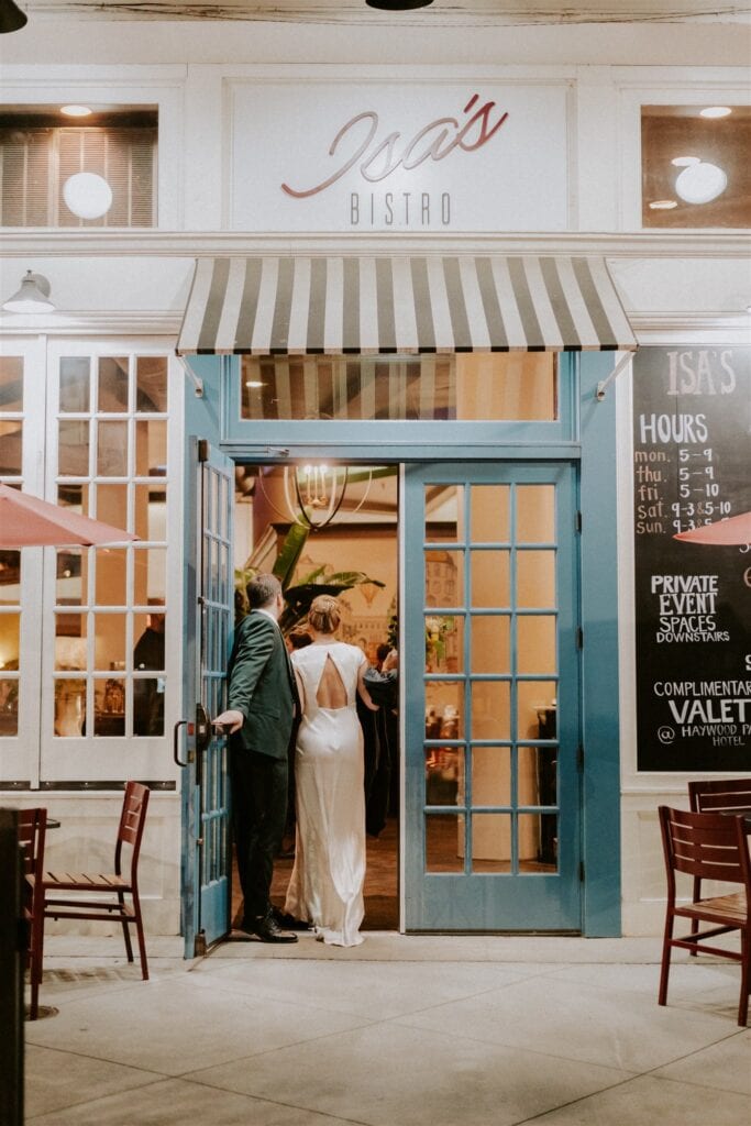 Bride and groom walking into isa's bistro in asheville north carolina