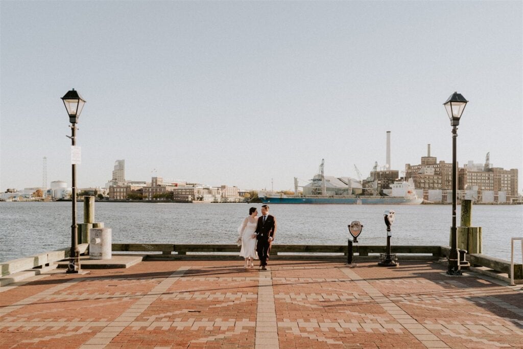 bride and groom walking around Fells Point for golden hour