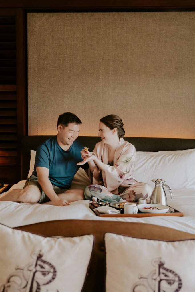 bride and groom enjoying a slow morning with coffee in bed at their hotel room