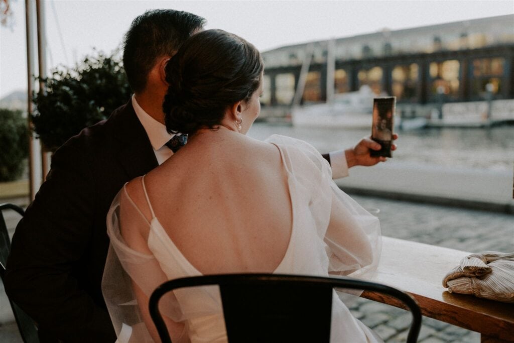 bride and groom sipping drinks at the vino wine bar