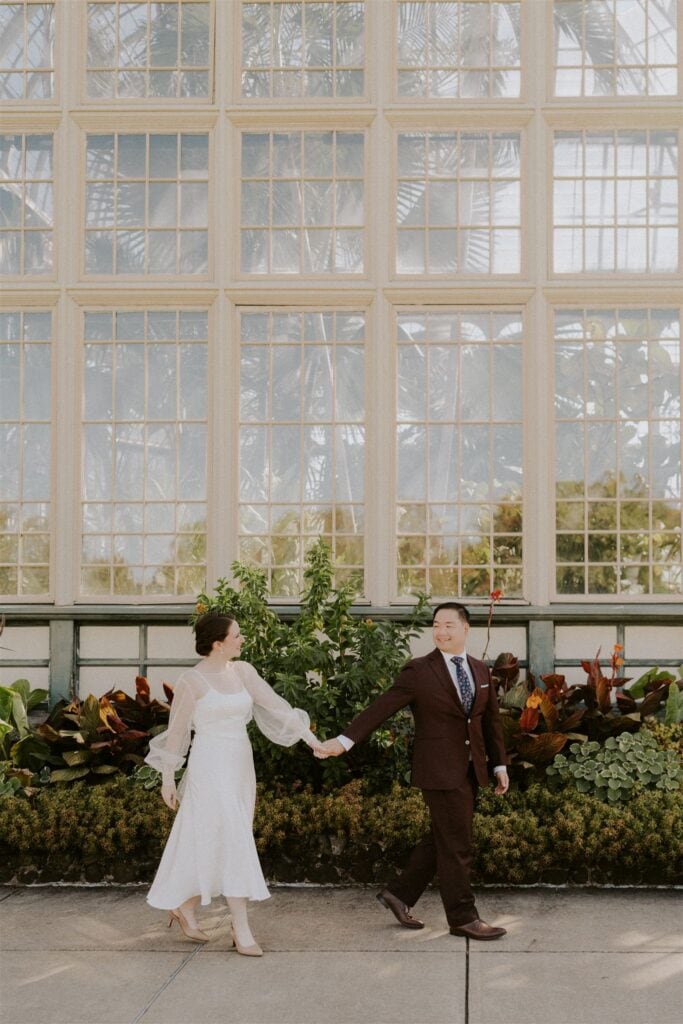 bride and groom in front of the rawlings conservatory