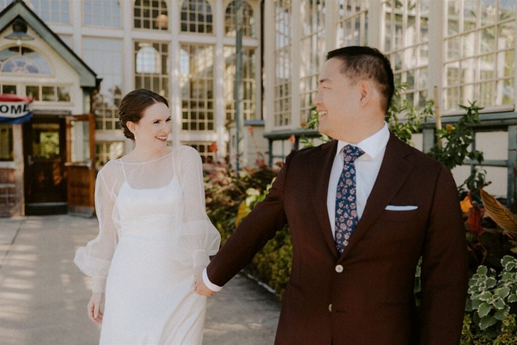 bride and groom in front of the rawlings conservatory