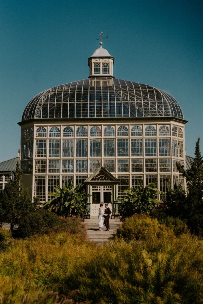 bride and groom in front of the rawlings conservatory