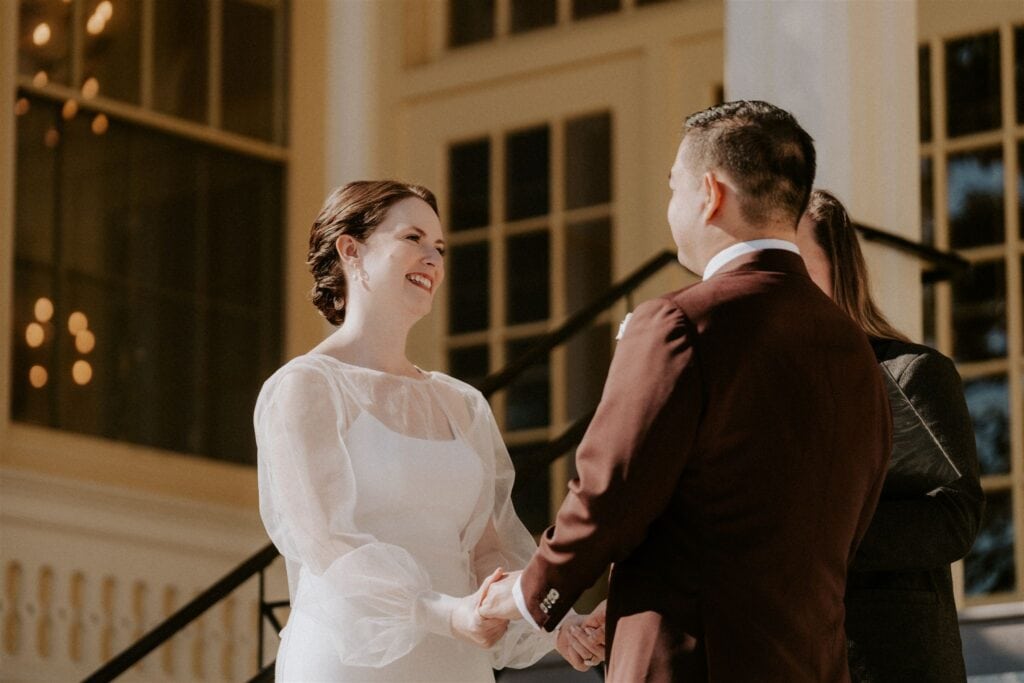 bride and groom exchanging vows in front of the zoo during their baltimore zoo wedding day