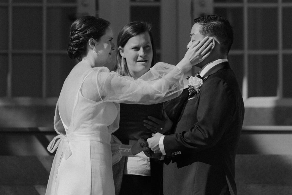 bride and groom exchanging vows in front of the zoo during their baltimore zoo wedding day