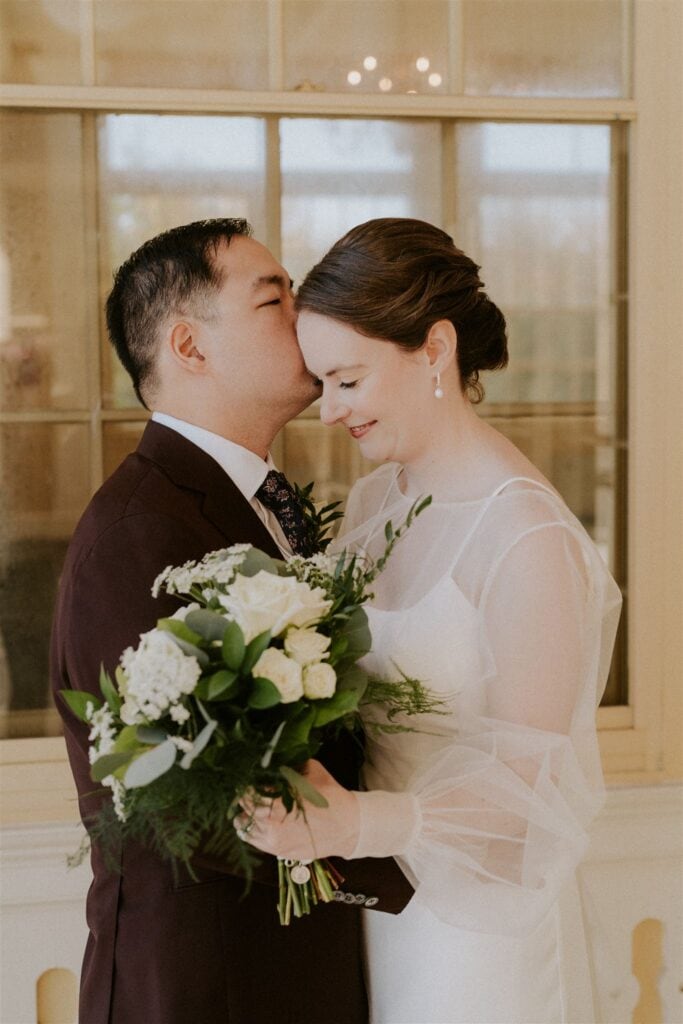 bride and groom posing in front of the zoo during their baltimore zoo wedding day