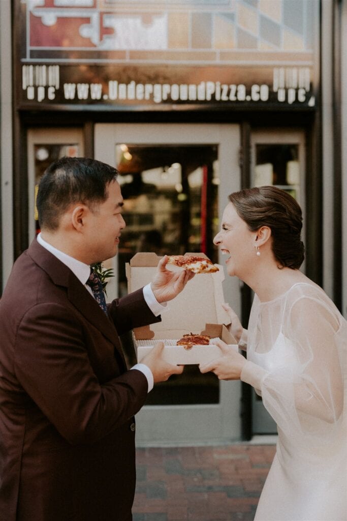 bride and groom enjoying pizza together during their baltimore elopement