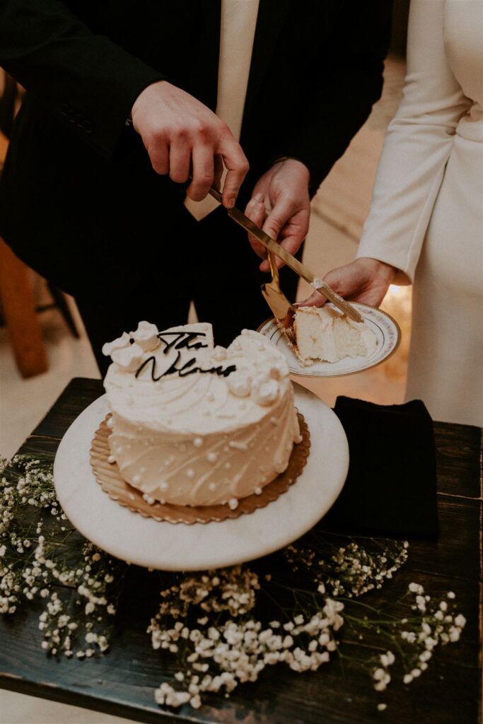 bride and groom cutting cake
