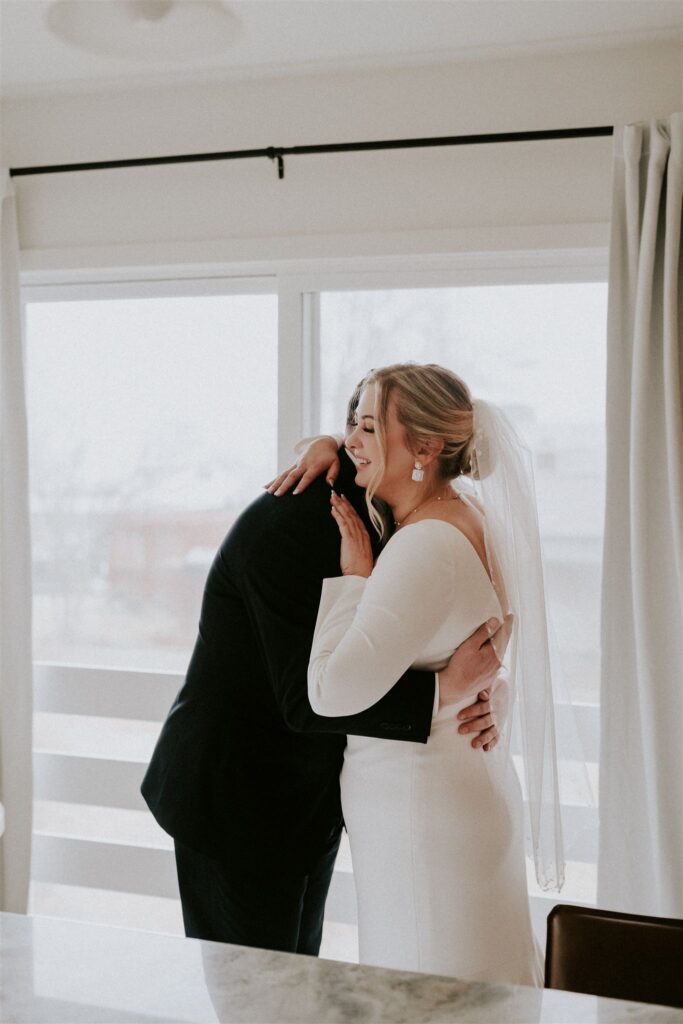 bride and groom first look at their living room
