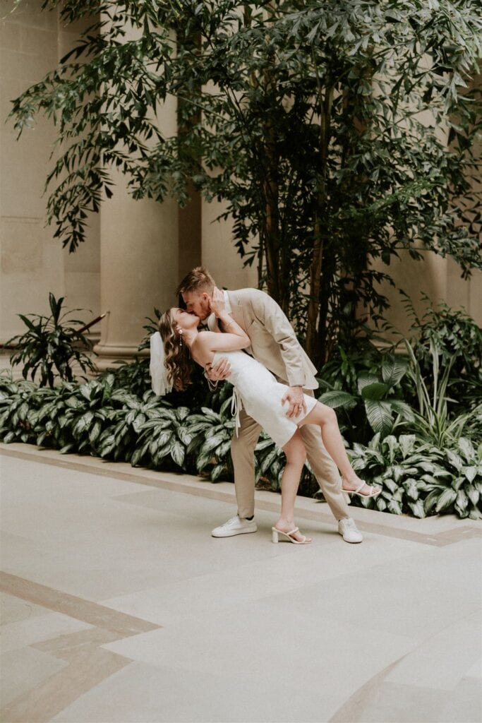 bride and groom dip kiss at the national gallery of art