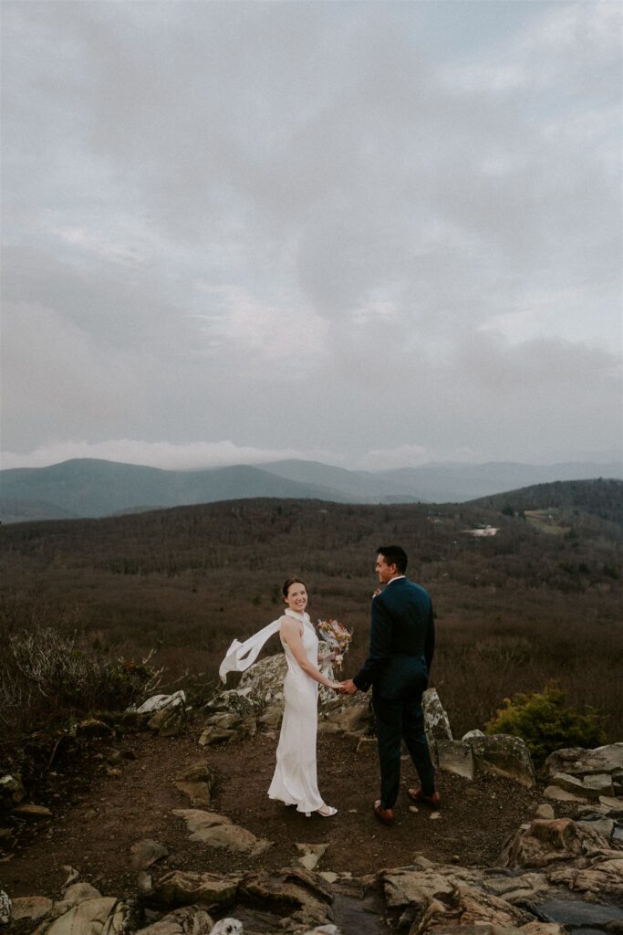 bride and groom hiking during their sunrise shenandoah national park elopement