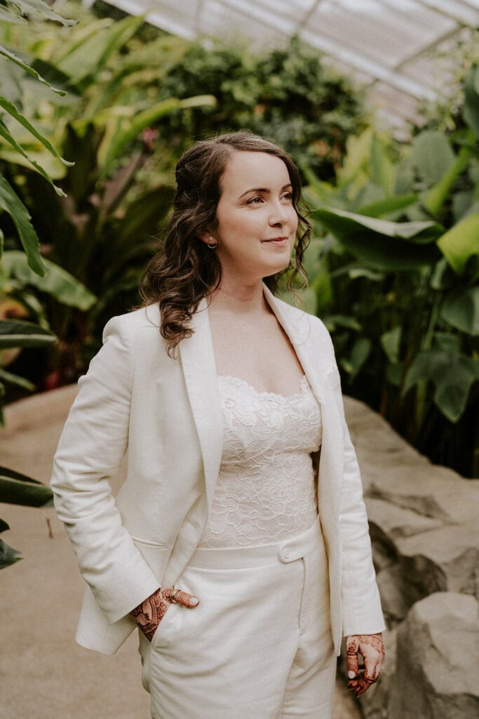 bride in a white suit at rawlings conservatory