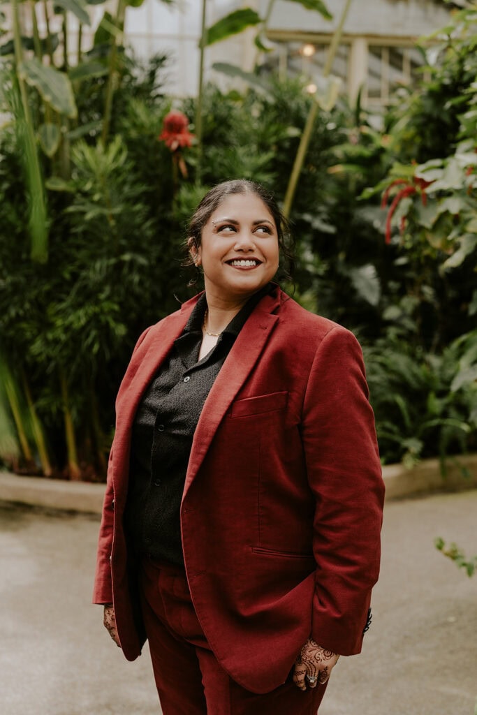 bride in a red suit at rawlings conservatory