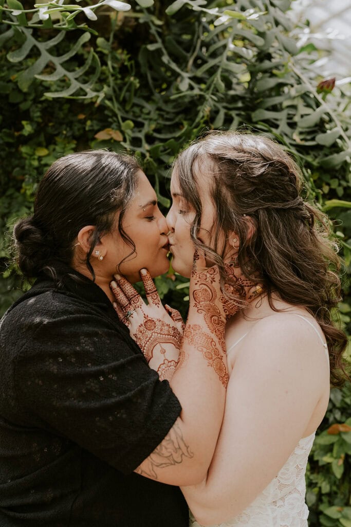 An Intentional Baltimore Elopement Rooted in South Asian Wedding Tradition 1 brides kissing at rawlings conservatory