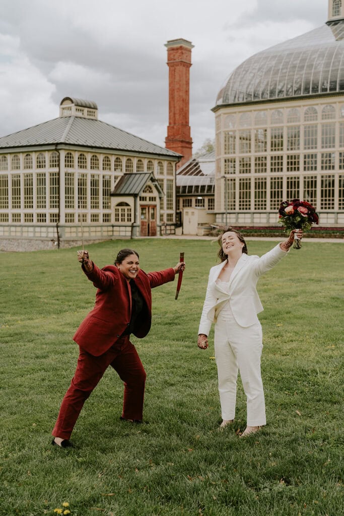 brides posing in front of rawlings conservatory