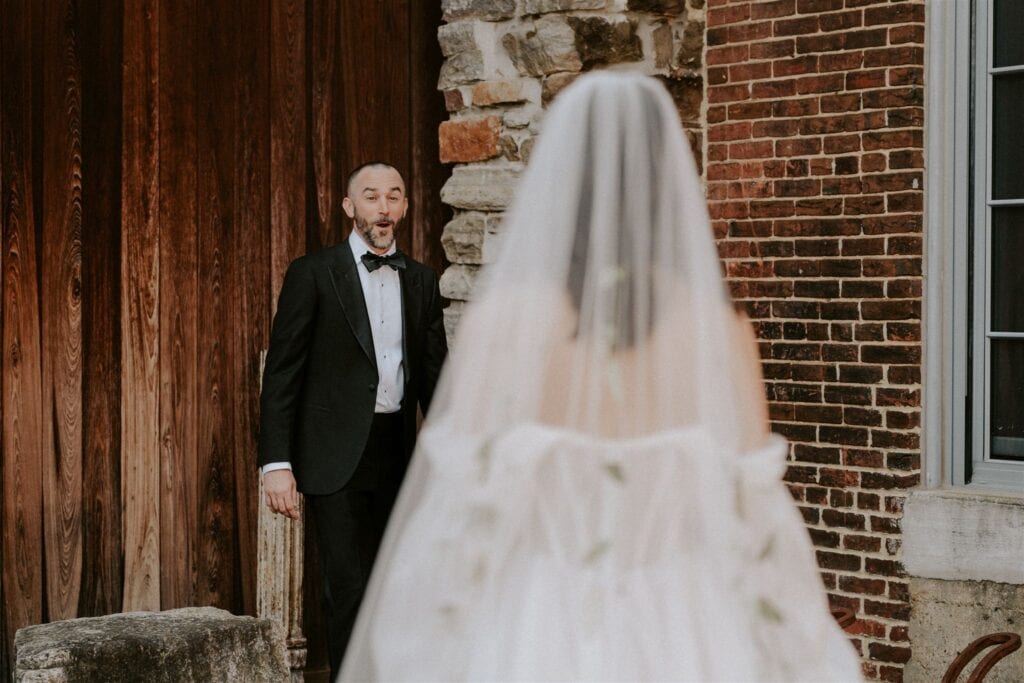 candid and emotional bride and groom first look