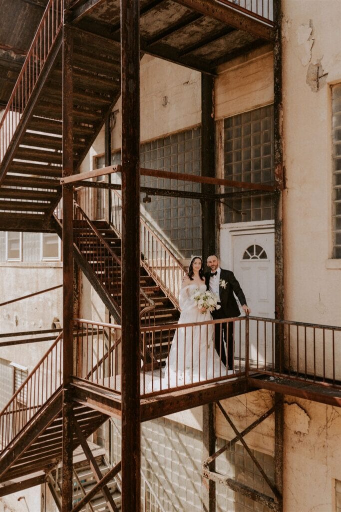bride and groom at an industrial building