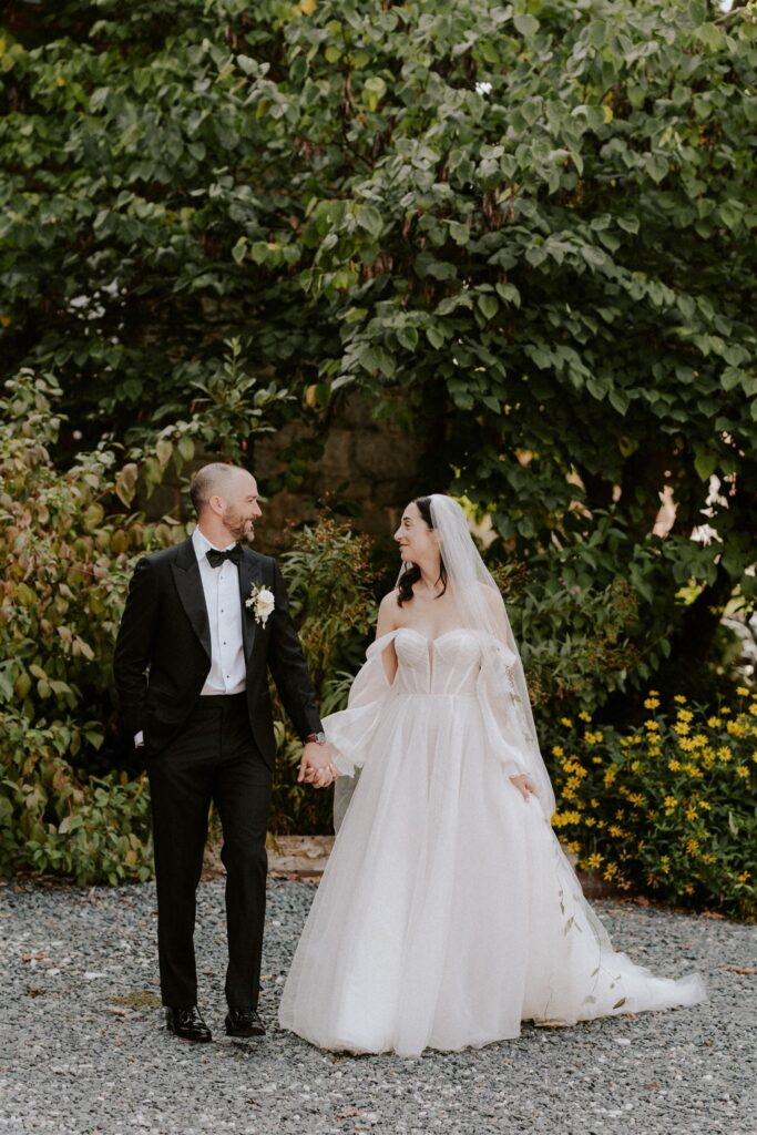 wedding couple in front of a lush greenery
