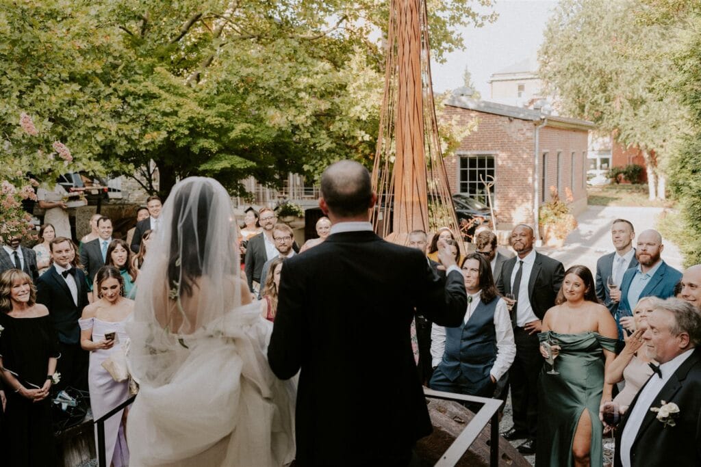bride and groom doing a speech for their families