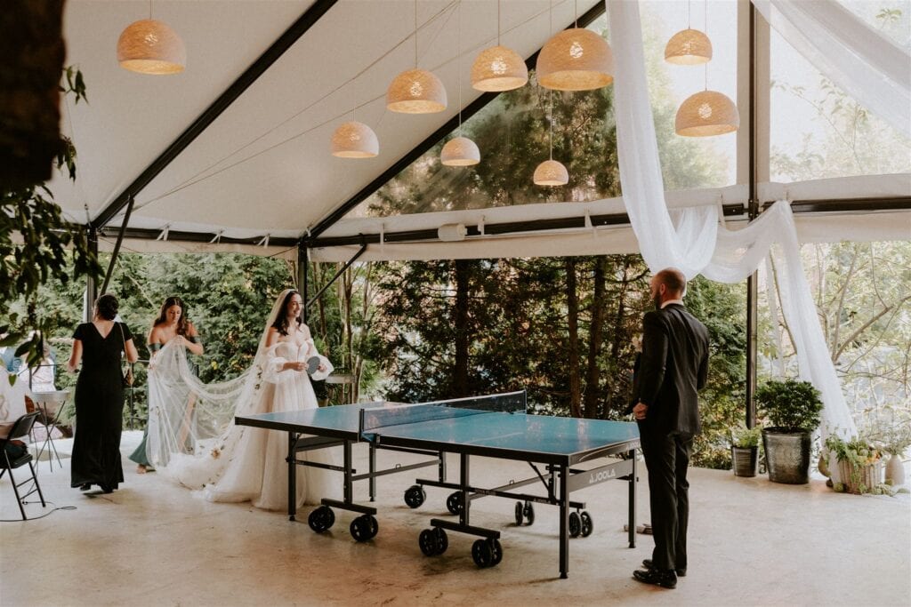 bride and groom playing ping pong